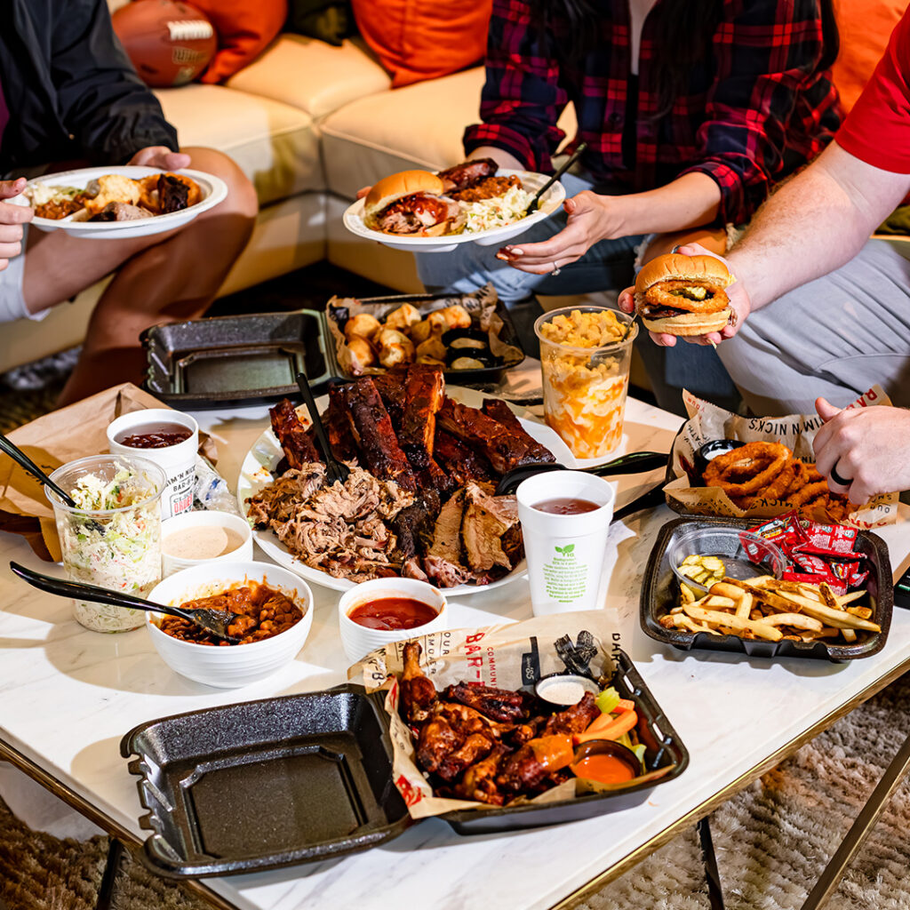 image of a group eating a bbq spread