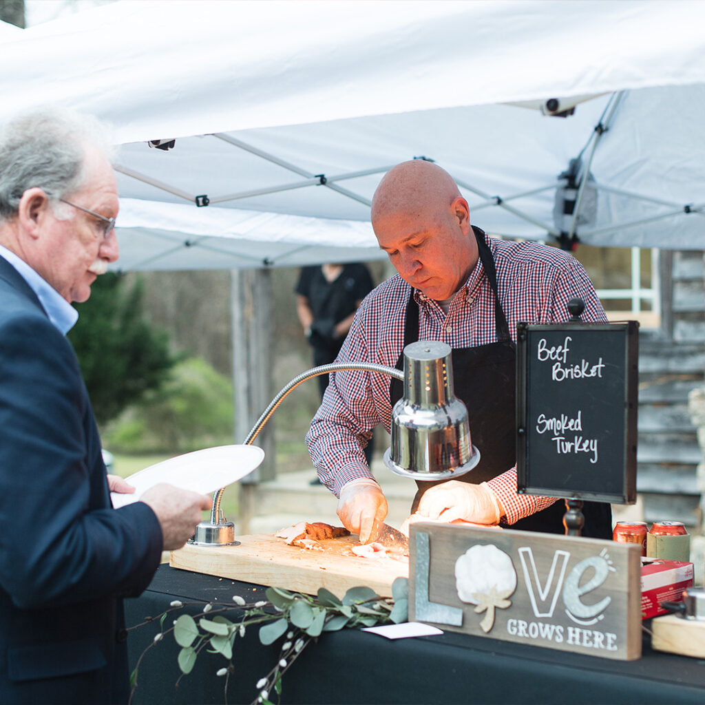 image of person cutting a protein at an event